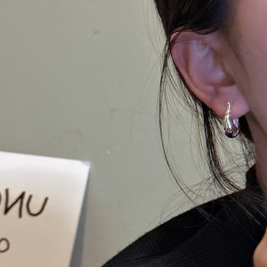 Boucles d'oreilles créoles goutte en argent S925 poli au style minimaliste sur modèle