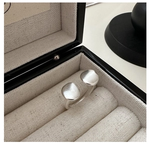 Detailed view of S925 sterling silver ring with matte texture and open wrap design