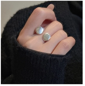 Macro shot of matte S925 sterling silver ring featuring irregular flat disc details