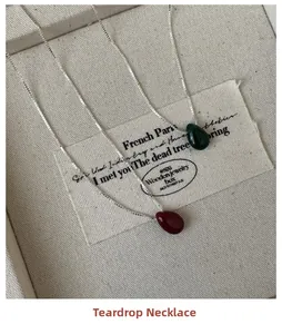 Detailed shot of dark green and burgundy waterdrop pendants on S925 silver box chain