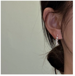 Detailed view of 925 sterling silver triple gradient bead drop earrings worn by a model