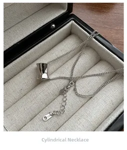 Macro shot of S925 sterling silver cylindrical pendant necklace in a luxury jewelry box