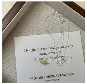 Close-up of S925 sterling silver chain with translucent green natural stone pendant