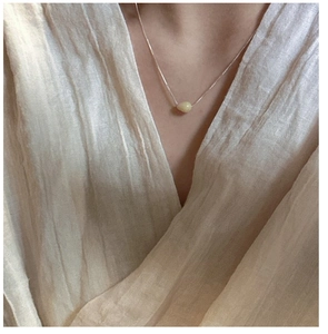 Detail of S925 sterling silver necklace with teardrop natural stone on female collarbone