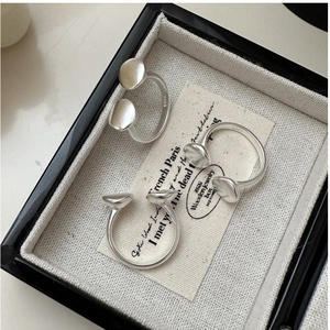 Close-up of S925 sterling silver rings with matte finish and engraved hallmark in jewelry box