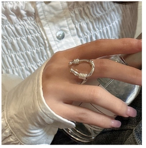 Macro view of S925 sterling silver U-shaped ring with textured ends on model finger