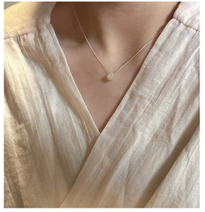 Detailed view of an S925 silver necklace featuring a translucent natural gemstone pendant