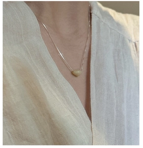 Detail of S925 sterling silver chain with a translucent pale yellow natural stone pendant