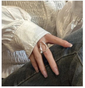 Detail of S925 sterling silver U-shaped ring with twisted wire texture on model's hand