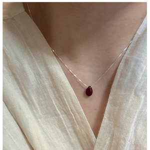 Close-up of S925 sterling silver necklace with teardrop red natural stone pendant