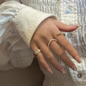 Macro shot of minimalist S925 sterling silver rings with elegant wrinkled textures