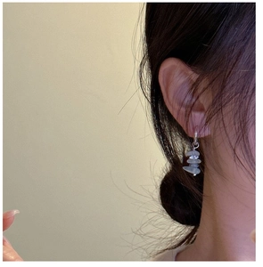 Close-up of handmade S925 sterling silver earrings with stacked light blue stone pendants