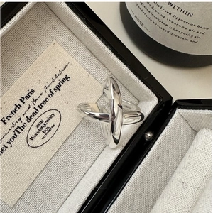 Detailed view of the silver cross design ring resting inside a velvet jewelry gift box