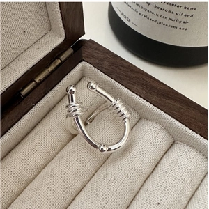 Close-up of S925 sterling silver U-shaped ring with minimalist wire wrap and beads