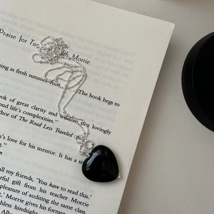 Minimalist S925 sterling silver black onyx heart pendant necklace on vintage book page