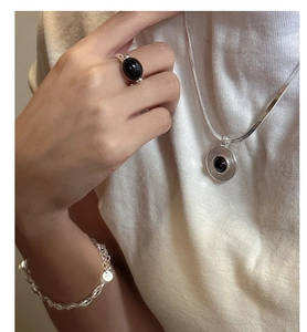Detail of s925 sterling silver necklace and ring with black onyx gemstone inlays