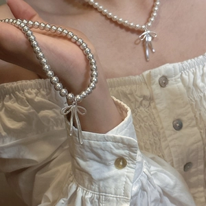 S925 sterling silver bead necklace and bracelet set with textured bow pendant on model