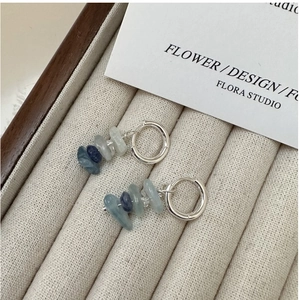 Detail of S925 sterling silver hoop earrings with irregular blue natural stone pendants