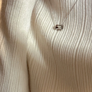 Minimalist S925 sterling silver cylinder pendant necklace on white knit background