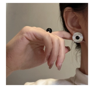 Macro detail of S925 silver earring set with textured black onyx and minimalist design