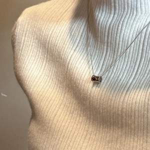 S925 sterling silver minimalist cylinder pendant necklace on a beige turtleneck sweater