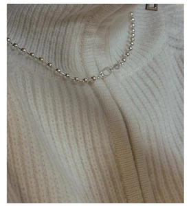 Close-up of a minimalist S925 silver bead chain necklace worn on a white knit sweater