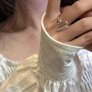 Close-up of minimalist S925 sterling silver open ring with geometric pointed ends design