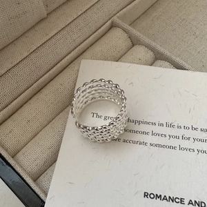 Close-up of a multilayer braided S925 sterling silver ring with an adjustable open design