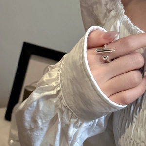 Close-up of minimalist S925 silver irregular geometric open ring on a model's finger