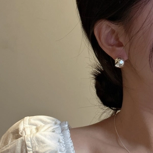 Chic 925 sterling silver C-shaped hoop earrings with hammered texture on model