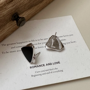 Detail view of S925 sterling silver triangle earrings with black enamel and hallmark stamp