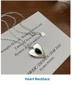 Detail of S925 sterling silver heart necklace with black agate on a gift card