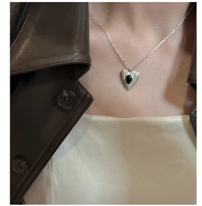 Close-up of S925 silver heart necklace with black agate pendant on neck