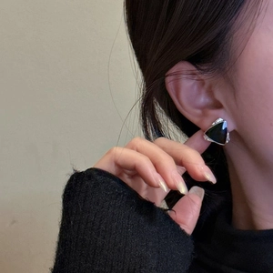 Elegant S925 sterling silver black triangle stud earrings worn by a female model