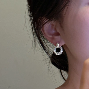 Textured S925 sterling silver hoop earrings shown on model for a minimalist fashion look