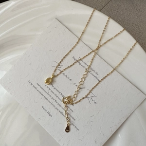 Detailed macro of gold S925 sterling silver U-shaped necklace with adjustable clasp chain