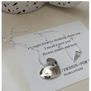 Macro detail of S925 sterling silver heart pendant with polished finish and O-chain
