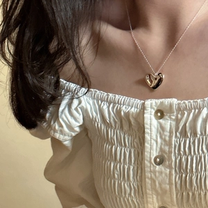 Minimalist S925 sterling silver heart pendant necklace shown on a model for a stylish look