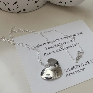 Minimalist S925 sterling silver heart pendant necklace on a clean white card background