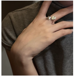 Detail of S925 sterling silver heart open ring worn on finger with minimalist design