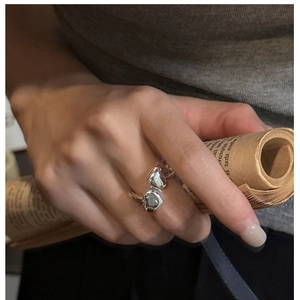 Macro detail of S925 sterling silver adjustable open ring with dual heart accents