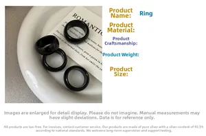 Detailed view of four minimalist black onyx S925 sterling silver rings set on a ceramic dish
