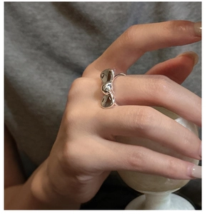 Close-up of S925 sterling silver bow ring worn on finger for a minimalist aesthetic
