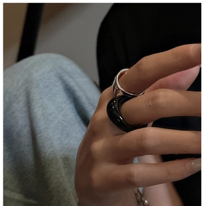 Minimalist stackable set with a smooth black resin ring and a slim silver metal band