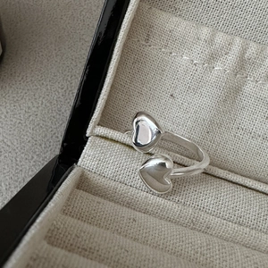 Minimalist S925 sterling silver open ring with double heart charms on a jewelry box