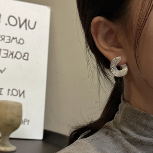 Elegant S925 sterling silver fan-shaped spiral earrings shown on model for a chic look