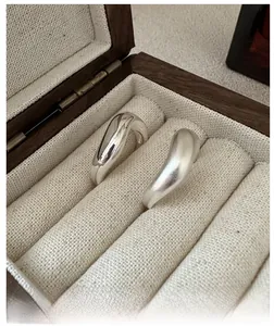Macro shot of minimalist S925 sterling silver rings with polished and matte brushed textures