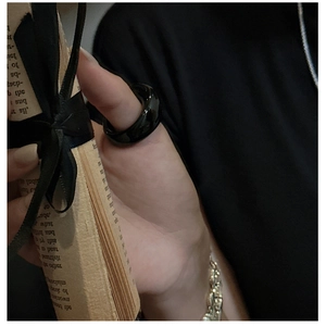 Polished black thumb ring shown on model for a trendy minimalist and unisex style