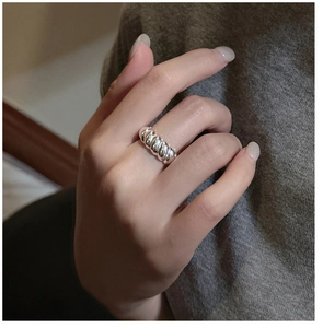 Silver croissant ring with retro twisted design shown worn on finger for a minimalist look