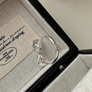 Minimalist S925 sterling silver bow ring with polished finish and open adjustable band